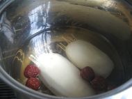 把酿好的糯米藕放入锅中，注入清水没过莲藕，在里面放入红糖和红枣，大火煮开后转小火煮约2小时<br />
